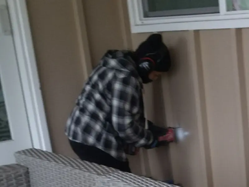 Professional electrician installing an exterior outlet in Ida