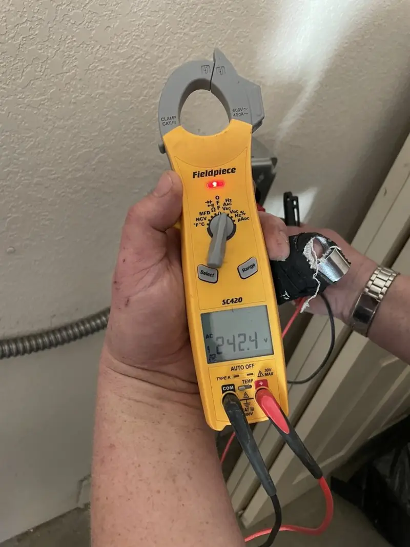 Voltage testing with clamp meter during Whole House Surge Protector in Ida